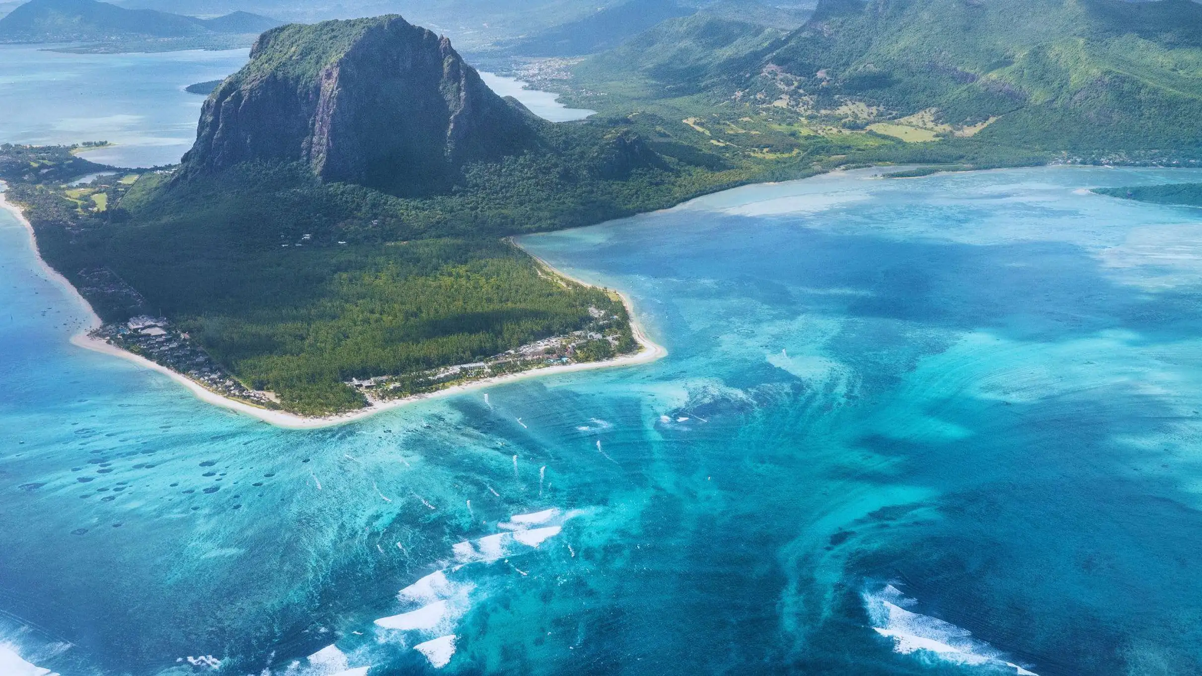 Helicopter flying over lush green mountains
